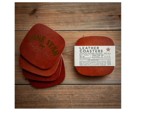 Set of red leather coasters with a label on a wooden surface