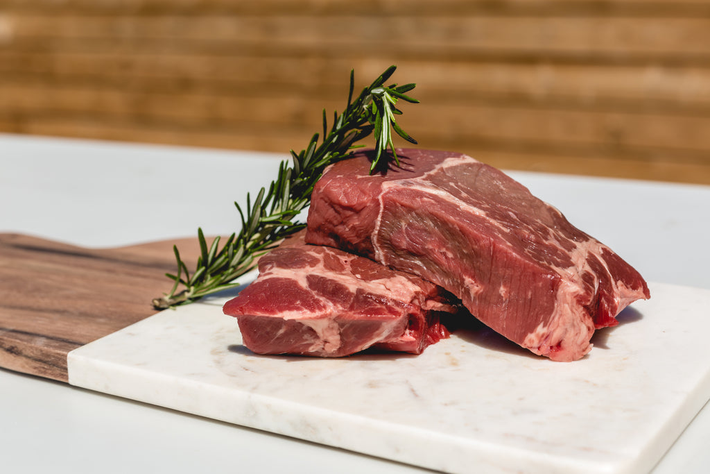 raw steak with rosemary